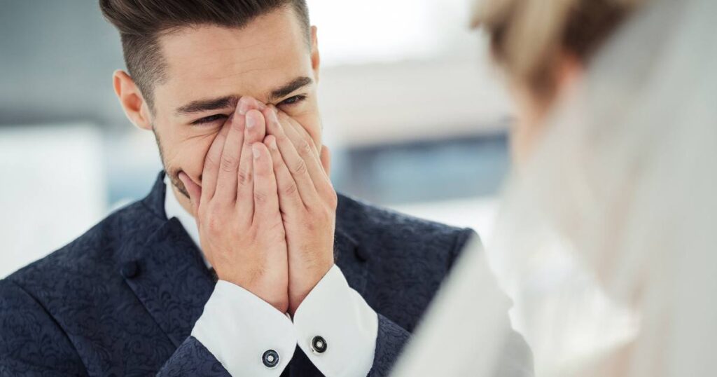 This is a wedding photo idea of a groom's emotional moment in front of the bride