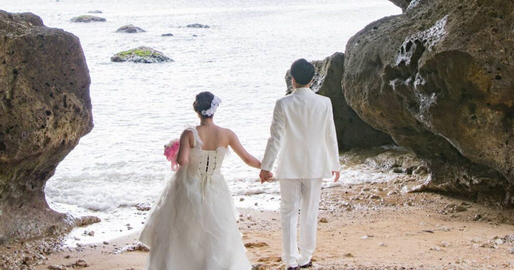 This is a wedding photo idea of a bride and groom in an exotic beach cove