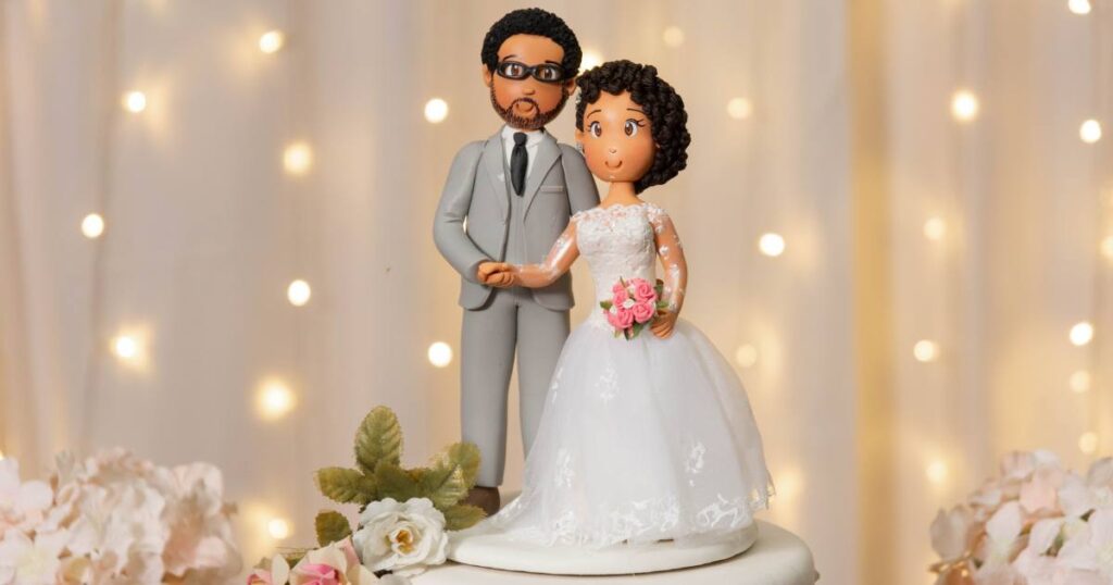 This is a wedding photo idea of incorporating a playful cake topper of the bride and groom.