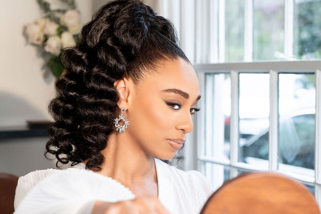 Black bride looking at herself in mirror on wedding day
Photographer: Ashley Nicole Photography
Venue: Atlanta History Center
Makeup Artist: @bforbeaute.co @glambymaame